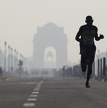 File photo shows Safari Rachid of Rwanda running past India Gate while competing in the men's marathon final during the Commonwealth Games in New Delhi