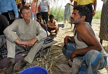 Microsoft Chairman Bill Gates interacts with a villager during a visit to Bihar in May