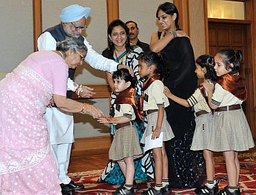 Prime Minister Dr Manmohan Singh with school children in New Delhi