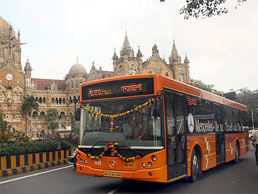 A Mercedes bus operated by BEST passes the iconic Chhatrapatti Shivaji Terminus in Mumbai