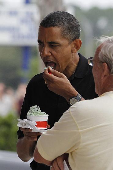 US President Barack Obama eats a cup of mint chocolate chip ice cream