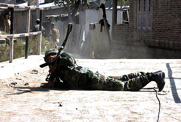 A soldier fires during the gunbattle