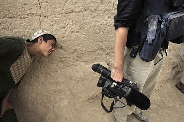Local boy peeks at a journalist's video camera in Saidon Kalacheh village in Afghanistan