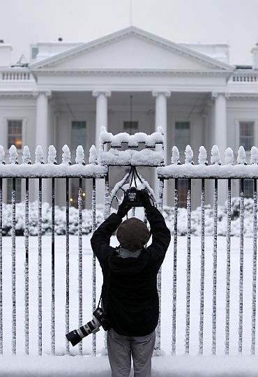 A photographer takes pictures of White House in Washington, DC