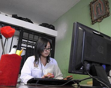 Marisol Valles Garcia sits at her desk at the police station in Praxedis G Guerrero
