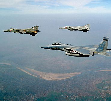 File photo shows two MIG-27 Floggers flying alongside an American F-15 Eagle