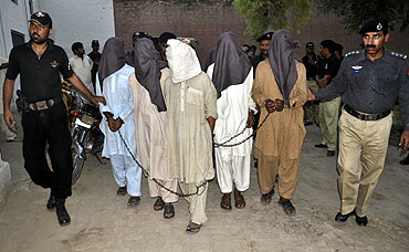 Police escort suspected militants to a prison in Bahawalpur, Pakistan