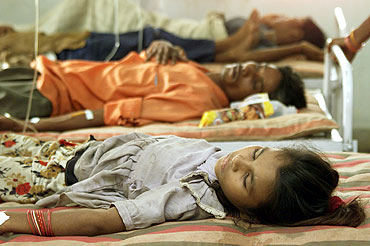 Indian flood victims Patients suffering from malaria lie on hospital beds in Alindra, Gujarat