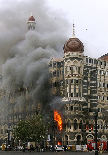 Taj Mahal hotel is seen engulfed in smoke during gun battle in Mumbai during 26/11 terror attacks