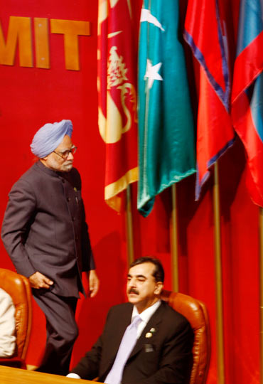 Prime Minister Manmohan Singh walks past Pakistan Prime Minister Yousaf Raza Gilani during the SAARC summit in Colombo