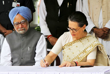 Congress president Sonia Gandhi watched by PM Singh while filing her nominations