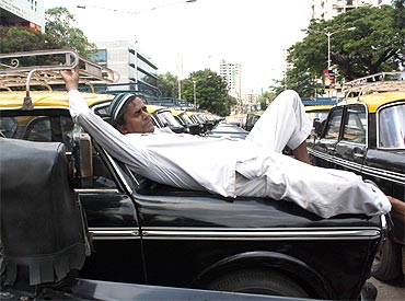 A cabbie takes a nap, not an uncommon sight in the city