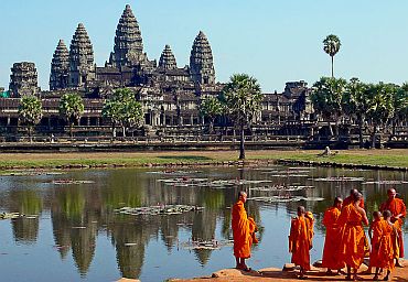 Buddhist monks in front of the reflection pool at Angkor Wat, Cambodia.