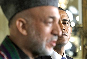 US President Barack Obama looks over at Afghanistan President Hamid Karzai during a news conference at the White House