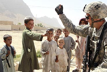 A US Army soldier gives a fist bump to residents in Kandahar province in Afghanistan