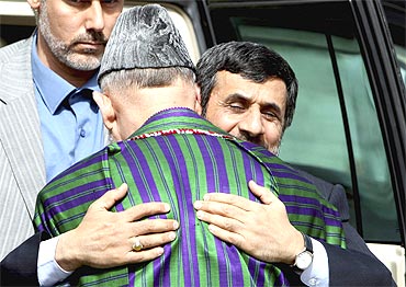 Afghan President Hamid Karzai welcomes his Iranian counterpart Mahmoud Ahmadinejad upon his arrival in Kabul