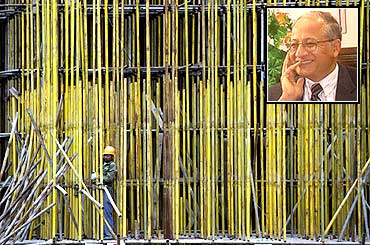A worker installs scaffolding at a construction site in Guangdong province, China. Inset: Girija Pande