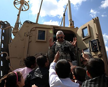 US Army Sgt 1st Class Refugio finishes handing out stuffed animals to children during a Kurdish New Year celebration in the Qarah Anir region of Kirkuk, Iraq, March 21, 2010