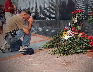 A mourner pays final respects at the Jacksonville Veterans Memorial Wall