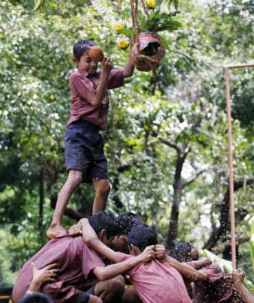 Visually impaired children form a human pyramid as they try to break a Dahi Handi