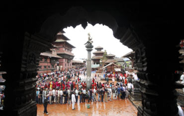 Devotees stand in a queue in front of the Krishna Temple in Patan