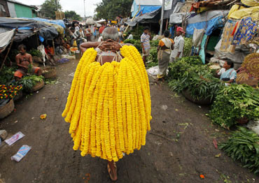 A vendor sells garlands of marigold flowers on Janamashtmi
