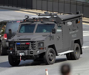 An armored police vehicle drives through the area near the Discovery Channel headquarters building