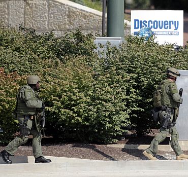 Armed police surround the area near the Discovery Channel headquarters building