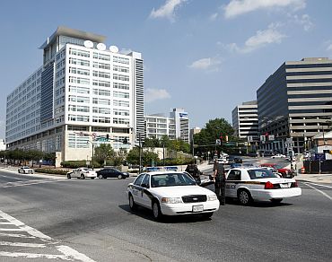 Montgomery County police vehicles keep a roadblock near the Discovery Channel headquarters