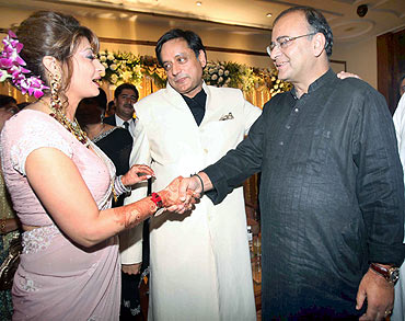Leader of Opposition in Rajya Sabha Arun Jaitely extends greetings to Tharoor and Pushkar at a reception in New Delhi