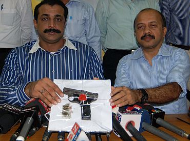 Joint Police Commissioner (Crime) Himanshu Roy (left) shows the weapon recovered from one of the hitmen