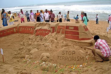 Patnaik gives finishing touches to a sand sculpture of Mumbai serial train blasts
