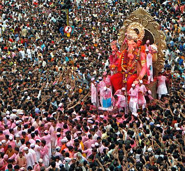 Devotees carry a Ganesh idol for immersion