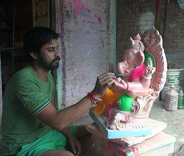 Dinesh Dhamne works on a Ganesh idol
