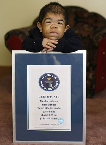 Edward Nino Hernandez poses with his Guinness World Records certificate in his home in Bogota