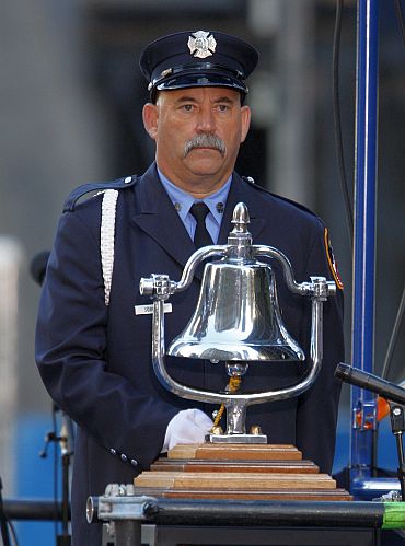 Fire Fighter James Sorokac rings the bell at 8:46am, starting a moment of silence observing the time the first plane struck the North Tower of the World Trade Centre, at the ninth anniversary remembrance of the attacks on New York and Washington, in New York
