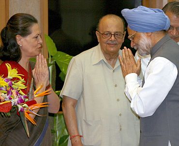 Congress chief Sonia Gandhi greets Dr Singh as senior party leader Arjun Singh looks on