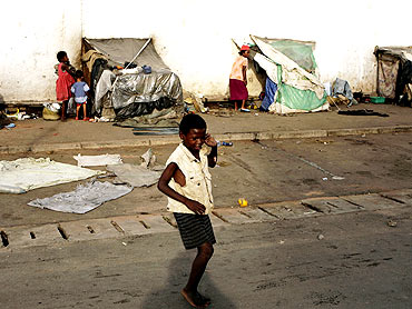 A homeless boy plays in front of makeshift huts in Nosybe outside Antananarivo, Madagascar
