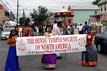 Children hold up a banner proclaiming Ganeshotsav outside the Flushing Ganesh temple