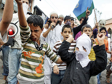 Kashmiris shout slogans during a protest on the outskirts of Srinagar