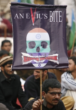A supporter of the Jamaat-e-Islami holds a banner at a protest to show solidarity with Kashmiris during an anti-India rally in Lahore