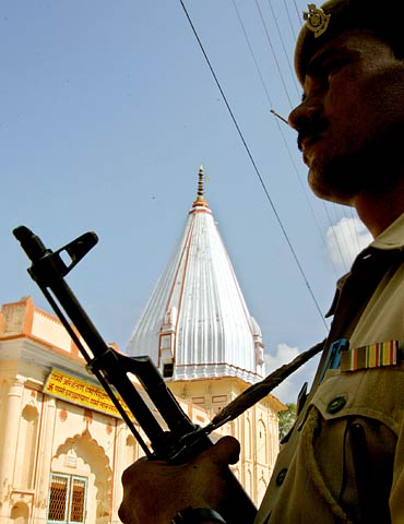 A policeman stands guard outside a temple in Ayodhya