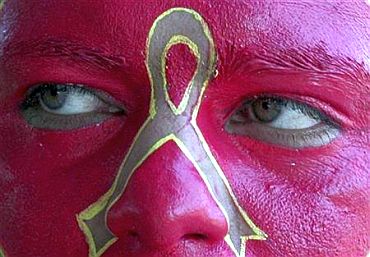 A social activist displays an AIDS symbol on his face during an awareness campaign in Chandigarh