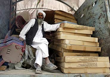 A worker waits to unload election materials from a truck at a polling centre outside Kabul.