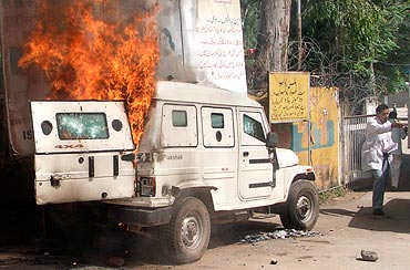 A burning armoured police vehicle after it was set on fire by demonstrators