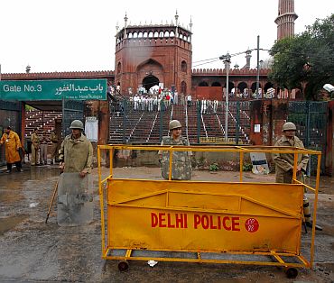 Police stand guard outside Jama Masjid after the shooting incident