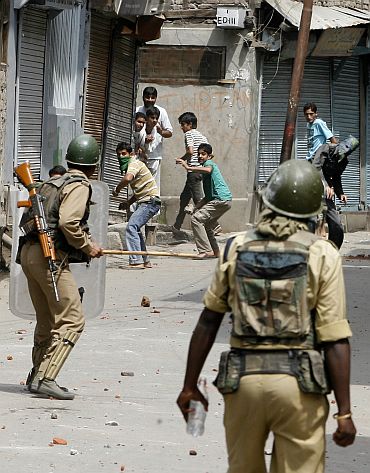 Kashmiri protesters throw stones at the police during a protest in Srinagar