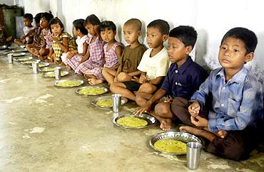 Children eat food at an anganwadi centre in Kutnabari village in Tripura