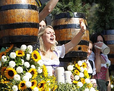 People in traditional Bavarian clothes take part in the Parade of the Landlords and Breweries during the opening of the 177th Oktoberfest in Munich