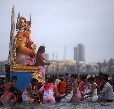 Devotees carry an idol of Ganesh, the deity of prosperity, for immersion in the sea on the last day of Ganesh Chaturthi, in Mumbai